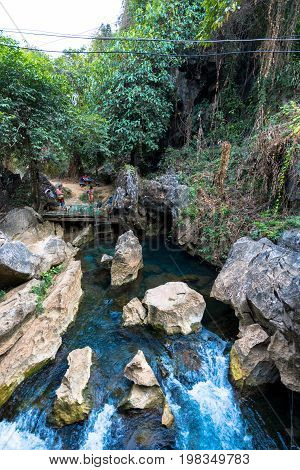 VANG VIENG LAOS - MARCH 14 2017: Vertical picture of Blue Lagoon at Tham Chang Cave close to the city of Vang Vieng Laos.