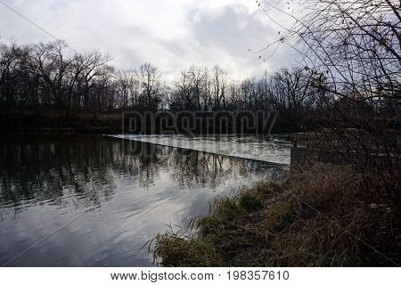 Water flows over a dam across the Du Page River in the Hammel Woods Forest Preserve in Shorewood, Illinois, during December.