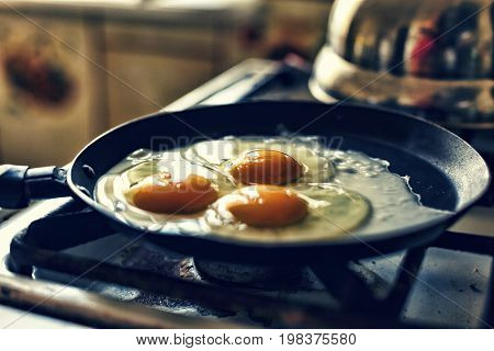 Eggs fry in a frying pan, morning