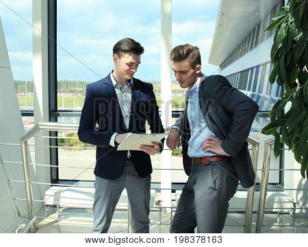 Two businessman dicussing business in the office