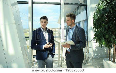 Two businessman dicussing business in the office