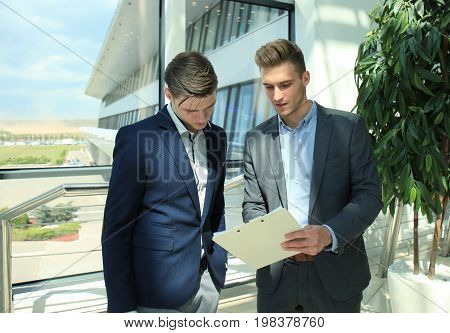 Two businessman dicussing business in the office