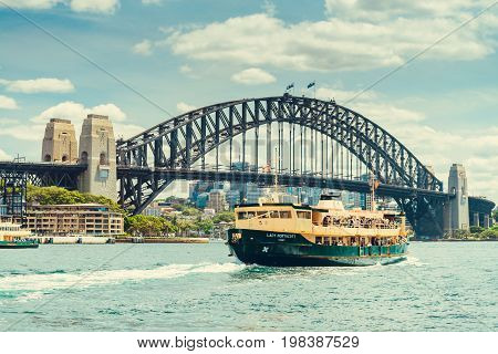 Sydney Australia - November 9 2015: Lady Northcott ferry with people onboard arriving at Cirqular Quay near Harbour Bridge on a warm sunny evening