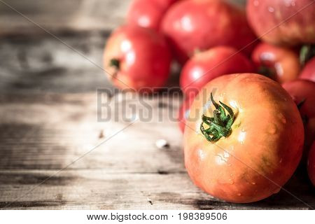 Ripe Tomatoes On Wooden Background Close-up