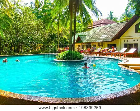 Railay, Krabi, Thailand - February 02, 2010: The people resting at pool at Sand Sea Resort at tropical Thailand island at Railay, Krabi, Thailand on February 02, 2010