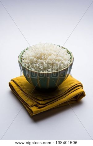 basmati rice in a ceramic bowl, indian white and long basmati rice cooked and served in bowl, selective focus