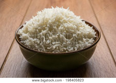 basmati rice in a ceramic bowl, indian white and long basmati rice cooked and served in bowl, selective focus