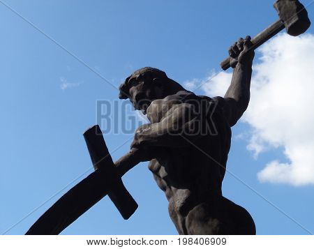 Kazakhstan, Ust-Kamenogorsk - August 02, 2017. Swords to ploughshares. The statue was designed by Yevgeny Vuchetich. Statue. Man. Muscular man. Sculpture.