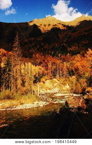 Mountains autumn landscape high peaks scenery wild nature calm scene. Lifestyle active travel hiking. Scenic scenery of wild snowy mountains and alpine valleys.