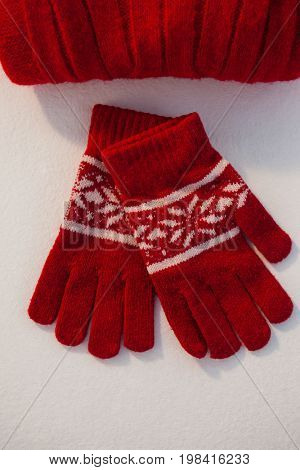 Overhead of wooly hat and gloves on white background