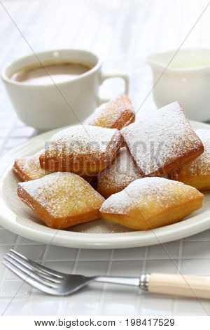 homemade new orleans beignet donuts and a cup of coffee