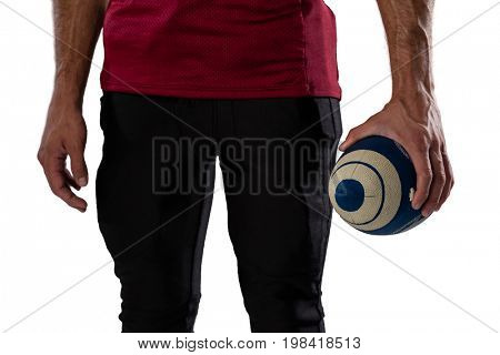Midsection of sportsperson holding ball against white background
