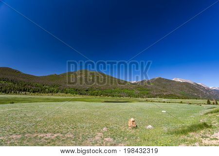 Trail Ridge Road is the name for a stretch of U.S. Highway 34 that traverses Rocky Mountain National Park from Estes Park Colorado in the east to Grand Lake Colorado in the west offering stunning mountain views.