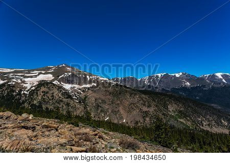 Trail Ridge Road is the name for a stretch of U.S. Highway 34 that traverses Rocky Mountain National Park from Estes Park Colorado in the east to Grand Lake Colorado in the west offering stunning mountain views.