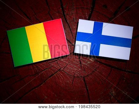 Malian Flag With Finnish Flag On A Tree Stump Isolated