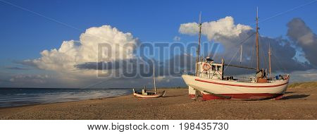 Fishing boat and summer clouds in the Jammerbugten Denmark.