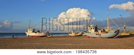 Summer afternoon at Slettestrand Denmark. Fishing boats on the shore.