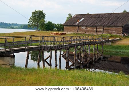 Wooden footbridge over pond. Kenozerye.Arkhangelsk region Russia