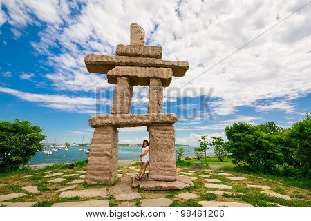 Toronto, Ontario, Canada, June 16, 2017 gorgeous amazing, inviting view of Toronto down town area outdoor park with natural landscape view and stunning inuksuk sculpture on dark blue sky background