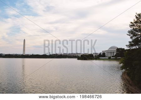 Panoramic view of Washington, D.C. skyline along the Tidal Basin at dawn.