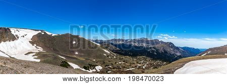 Trail Ridge Road is the name for a stretch of U.S. Highway 34 that traverses Rocky Mountain National Park from Estes Park Colorado in the east to Grand Lake Colorado in the west offering stunning mountain views.
