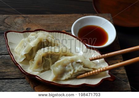 Jiaozi is Chinese food with pork in dough sheet.