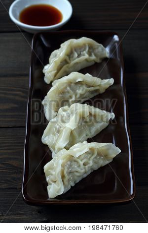 Jiaozi is Chinese food with pork in dough sheet.