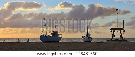 Summer evening at the Slettestrand Jammerbugten. Fishing boats at sunset.