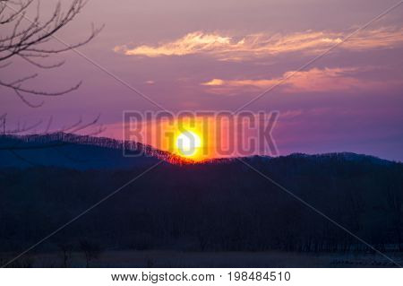 Sunrise in the summer morning over the hills in Primorye.