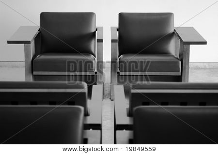 A pair of elegant wood and leather chairs