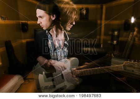 Guitarist in double exposure. Split personality. Musical recording studio, dark heavy music, psychological condition with drugs