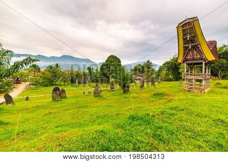 Tipical Boat Shaped Roofs Of An Ancient Traditional Wooden Building Around A Cluster Of Megaliths On