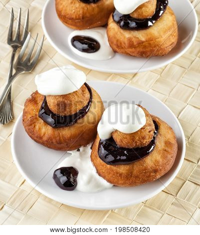 Sweet dessert of beignets with chocolate and cream