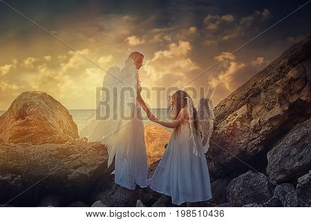 Angels. Mom and daughter with white wings