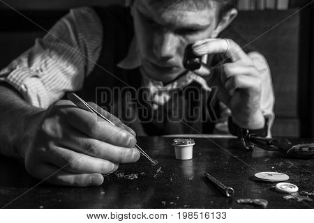 The watchmaker is repairing the mechanical watches in his workshop