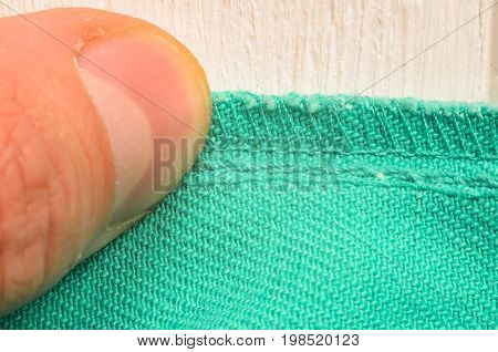 Inner seam on clothes pressed close to the table with hands. Close-up shot of a tailor at work