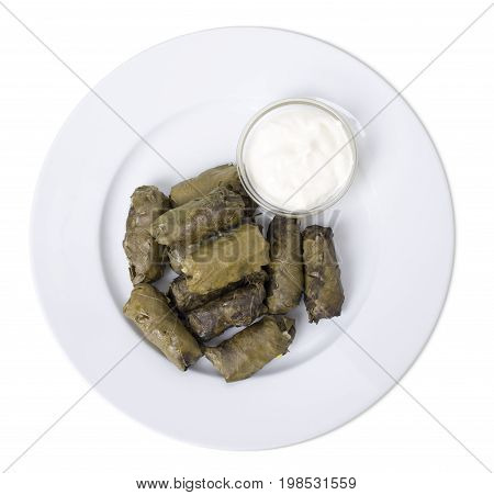 Stuffed grape leaves with sour cream.   Isolated on a white background.