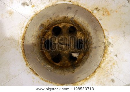 Close up of dirty water drain of bathtub.