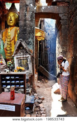 Thai Woman Praying Ruins Buddha Statue Image At Vat Phou Or Wat Phu