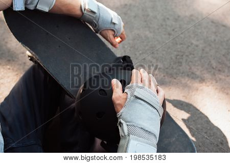 Skateboard halmet and gloves acessrise. Head and hands care protection from injoury. Extreme sport headwear stuff for skater