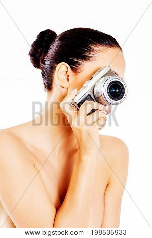 Nude beautiful woman with photo camera. Isolated on white.