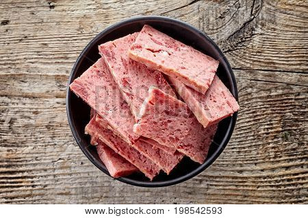 Bowl Of Sliced Ham On Wood; From Above
