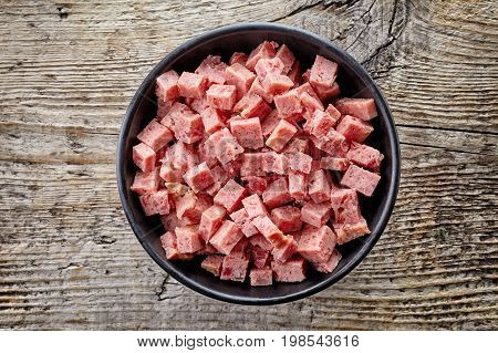 Bowl Of Sliced Ham On Wood; From Above