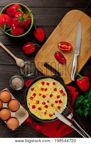 Breakfast. Cooking of an omelette with sweet red bolgarian peppers. Selective focus.