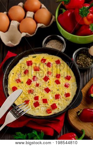 Breakfast. Cooking of an omelette with sweet red bolgarian peppers. Selective focus.