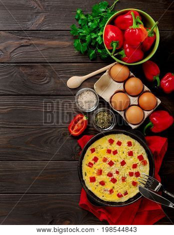 Breakfast. Cooking of an omelete with sweet red bolgarian peppers. Selective focus.