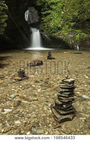 Beautiful Flowing Waterfall With Magical Fairytale Feel In Lush Green Forest Location