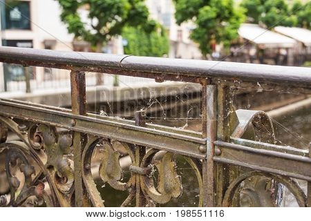 Spider Web on black old Railing outdoors