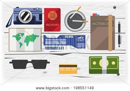 set of objects on a journey in the flat style top view on wooden background