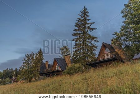 Cottages with sunset in summer evening near Kasarna village in west Slovakia